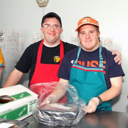 Two men supported by Liberty ARC with aprons on.